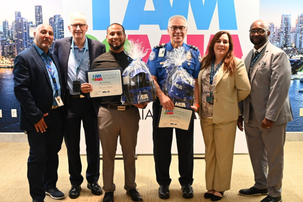 May 2024 Employees of the Month Alexander Guzman (center left), Robert Colon (center right), MIA Deputy Director Ken Pyatt (second from left), and TSA supervisors.