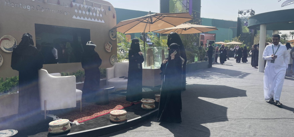 Attendees at the Saudi Media Forum explore virtual reality technology at the Saudi Heritage Commission stand in the outdoor exhibition and demo area.